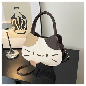 Close-up of cat-shaped crossbody bag featuring contrast stitching and gold hardware