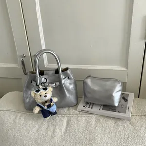 Silver metallic bucket bag set with matching zipper pouch and cute bear charm detail