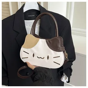 Detail of cute cat shaped leather handbag with color block ears and embroidery