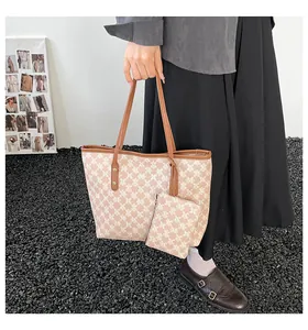 Detailed view of vintage tote bag set with monogram pattern and matching small pouch