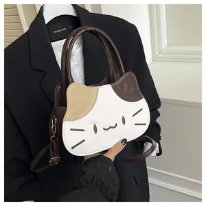 Detailed embroidery of cat face on a tricolor faux leather crossbody handbag