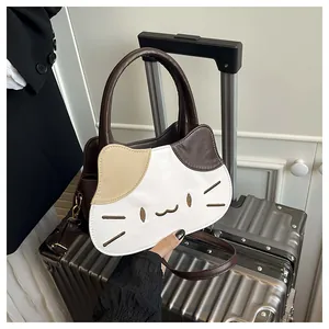 Detailed view of creative cat-shaped bag with contrast stitching on silver suitcase