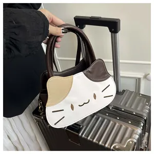 Detailed view of cat-shaped handbag featuring contrast color stitching and embroidery