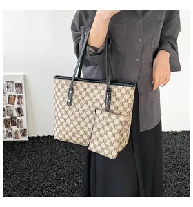 Detail view of khaki tote bag set with M-pattern monogram and matching zipper pouch