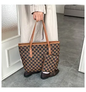 Detail of vintage tote bag set with monogram print and matching small pouch