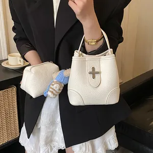 Cream bucket bag and pouch set with teddy bear charm in high-quality pebbled faux leather