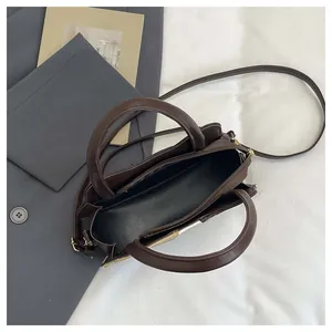 Top view of deep brown PU leather bag interior with zipper pocket and adjustable strap