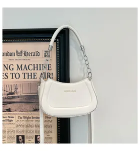 Seitenansicht der cremeweißen PU-Lederhandtasche mit Goldtext und silberner Kette