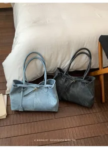 Close-up of retro minimalist tote bags in blue and grey on wooden floor background