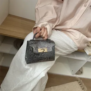 Metallic silver snake pattern mini handbag with gold twist lock and single handle for women