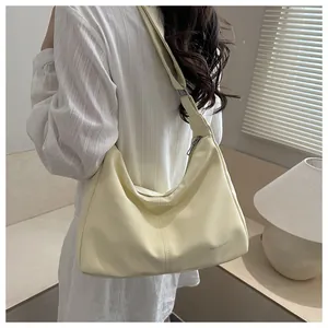 Model wearing a creamy yellow large capacity faux leather crossbody shoulder bag