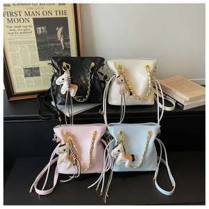 Detail view of four-color quilted bucket bags with gold chains and pony charms