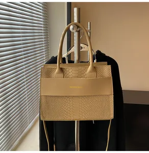 Dettaglio ravvicinato della trama a serpente sulla borsa a tracolla beige alla moda