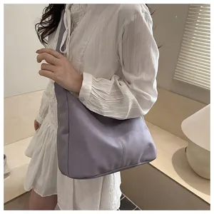 Detail shot of the elegant purple PU leather handbag with fine stitching and soft texture