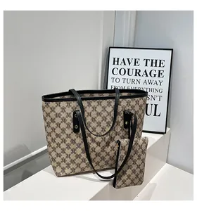 Close-up of retro jacquard tote bag set with monogram pattern and leather straps