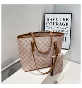 Detail view of retro monogram tote bag set with matching small zipper pouch and leather trim