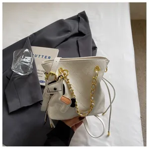 Detail of off-white bucket bag with quilted texture, gold chain and horse charm