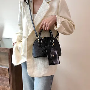 Elegant black crocodile-pattern shell bag with stylish small pouch and gold zipper detail