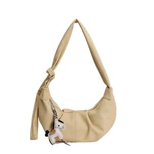 Elegante cremefarbene Halbmond-Lederhandtasche mit Knotengurt und Pferdeanhänger