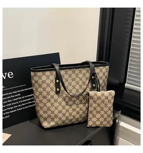 Detail view of vintage monogram tote bag set with brown pattern and gold hardware