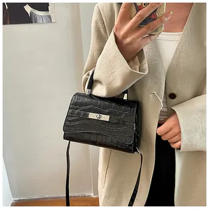 Mirror selfie showing the black crocodile pattern mini crossbody bag on a beige blazer