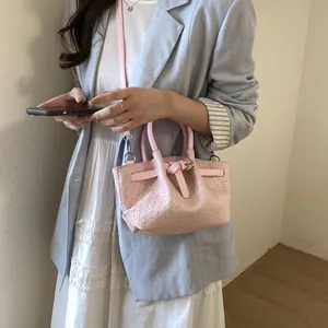 Pink woven bucket bag for women with dual top handles and detachable shoulder strap