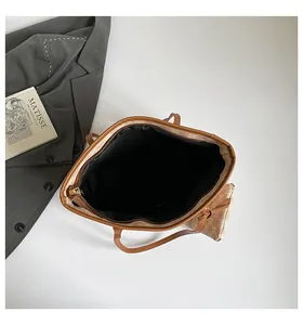 Top view of retro tote bag with brown letter patterns and spacious black interior lining