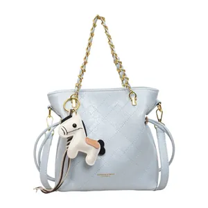 Stylish light blue quilted bucket bag with golden chain strap and cute horse charm