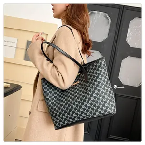 Detail view of large tote bag with M-letter print and metallic JINGPIN logo