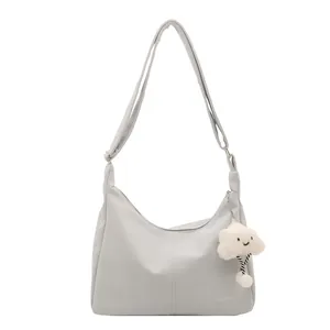 Light grey hobo shoulder bag with plush cloud charm and Tidal Dryness print
