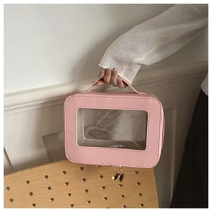 Detailed view of a pink waterproof cosmetic bag with transparent window and heart zipper