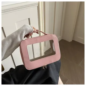 Pink Saffiano leather makeup bag with clear window and gold dual zipper handles