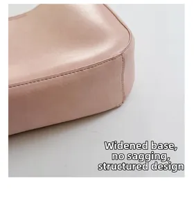 Close-up of the widened sturdy base on a pink leather handbag ensuring a structured shape