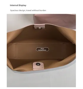 Top view of pink handbag interior showing spacious brown lining and magnetic snap button