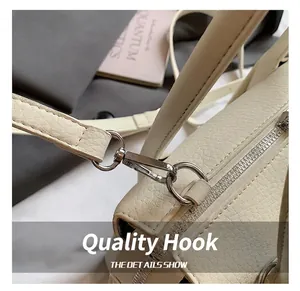 Detail shot of sturdy metal hook and zipper on cream lychee pattern crossbody bag