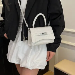 White faux leather crossbody bag with crocodile texture and silver turn-lock closure