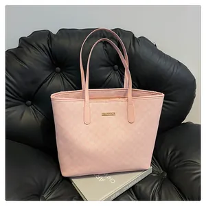 Detail of light pink tote bag with M letter monogram print and gold metal logo plaque