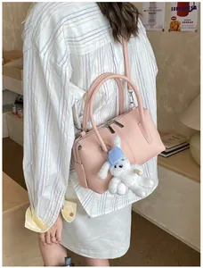 Pink Boston handbag with leather texture and cute white rabbit plush charm detail