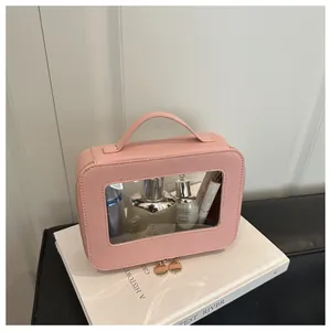 Detailed top view of pink cross-grain leather makeup bag with clear PVC window
