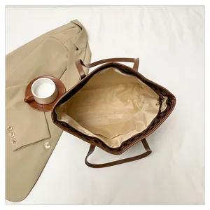 Interior view of large tote bag with zipper closure and practical inner storage pocket