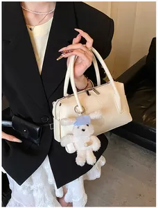 Chic beige lychee textured handbag with cute rabbit charm and dual zippers for women