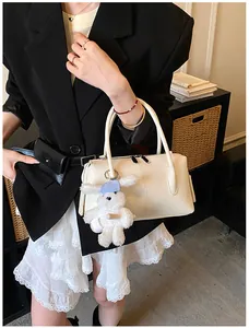 Cream boston handbag with lychee leather texture and cute white rabbit plush charm detail
