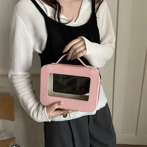 Pink waterproof transparent square handbag with faux leather texture and top handle