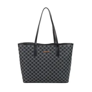 Black tote bag with repeating M-letter print pattern and gold logo plaque on front