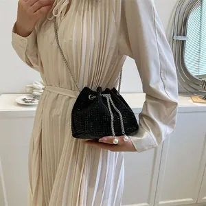 Elegant black rhinestone bucket bag with silver chain strap and pearl drawstring details