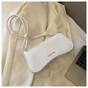 Detail of white crocodile pattern shoulder bag with FASHION & BAGS gold text