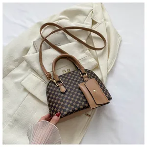 Detail of shell-shaped handbag with vintage pattern and a small matching coin purse
