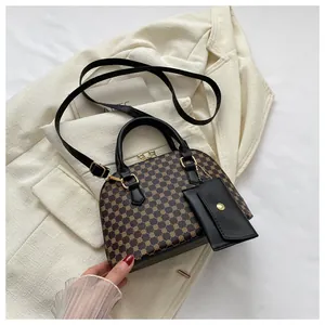 Detail of vintage Boston bag featuring retro pattern with detachable strap and coin purse