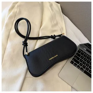 Top view of black crocodile pattern PU leather underarm bag with gold metallic details