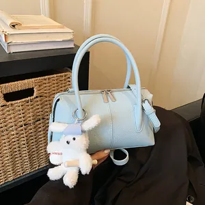 Pale blue lychee grain leather Boston bag with plush charm and detachable shoulder strap